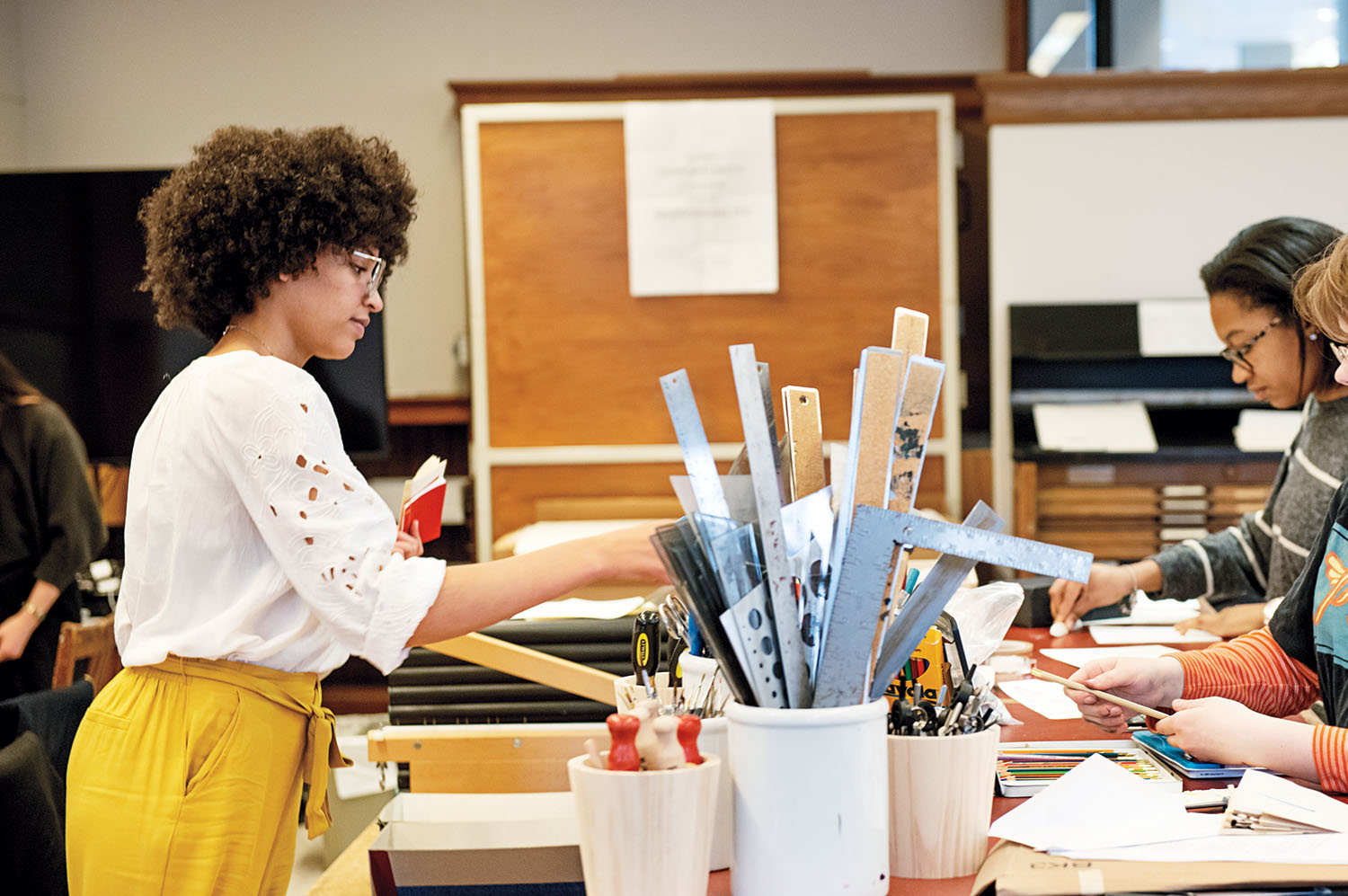 Students work on print projects in the book arts lab