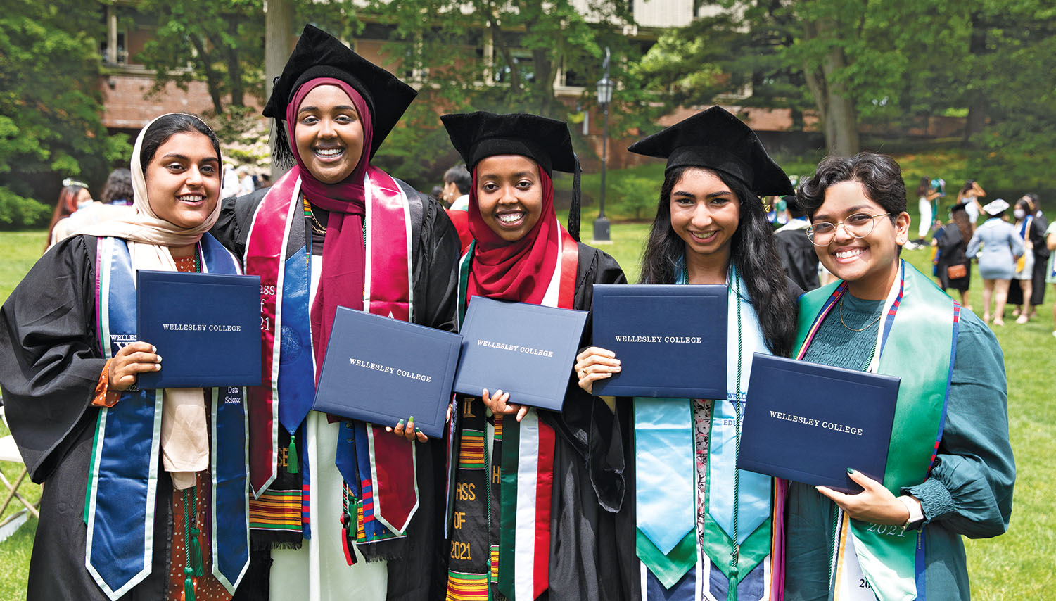 A group of students proudly display their diplomas.