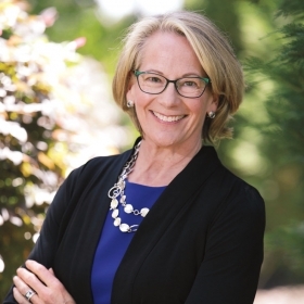 A photo portrait shows the new WCAA president, Laura Wood Cantopher '84, wearing a Wellesley-blue top.