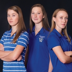 Kate, Caroline, and Ryan MacVicar pose in their Wellesley golf shirts