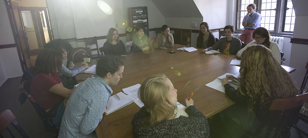 Students sit around table to discuss schoolwork