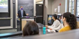 a person talking to a group of students