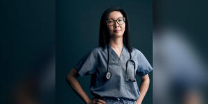 A portrait of Dr. Michelle Au ’99 in her scrubs and with a stethoscope around her neck.