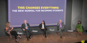 panelists sit on a stage