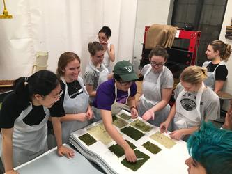 Students sample paper made with phragmite fiber